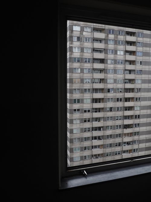 Free Urban Berlin high-rise building view through a window. Captures city architecture insight. Stock Photo
