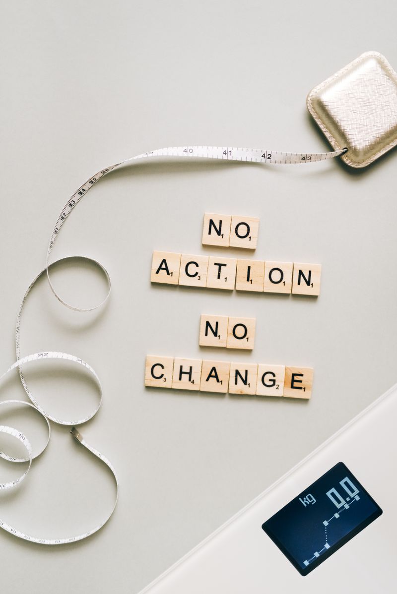 Letter tiles forming a motivational message alongside a scale and measuring tape