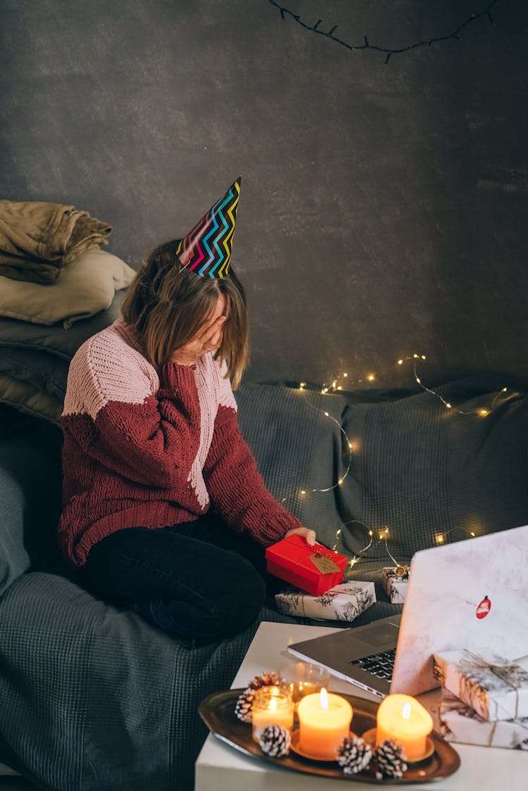 Woman In Red Sweater Opening Gifts