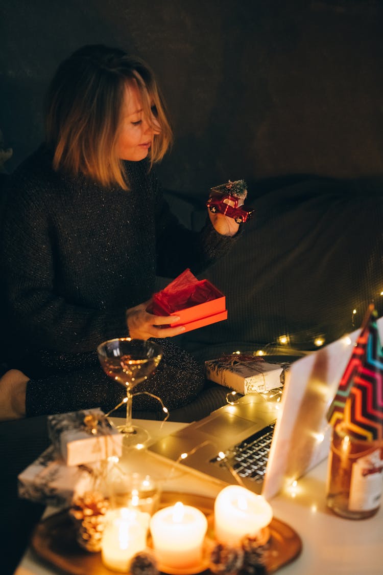 Woman In Black Long Sleeves Opening Gifts