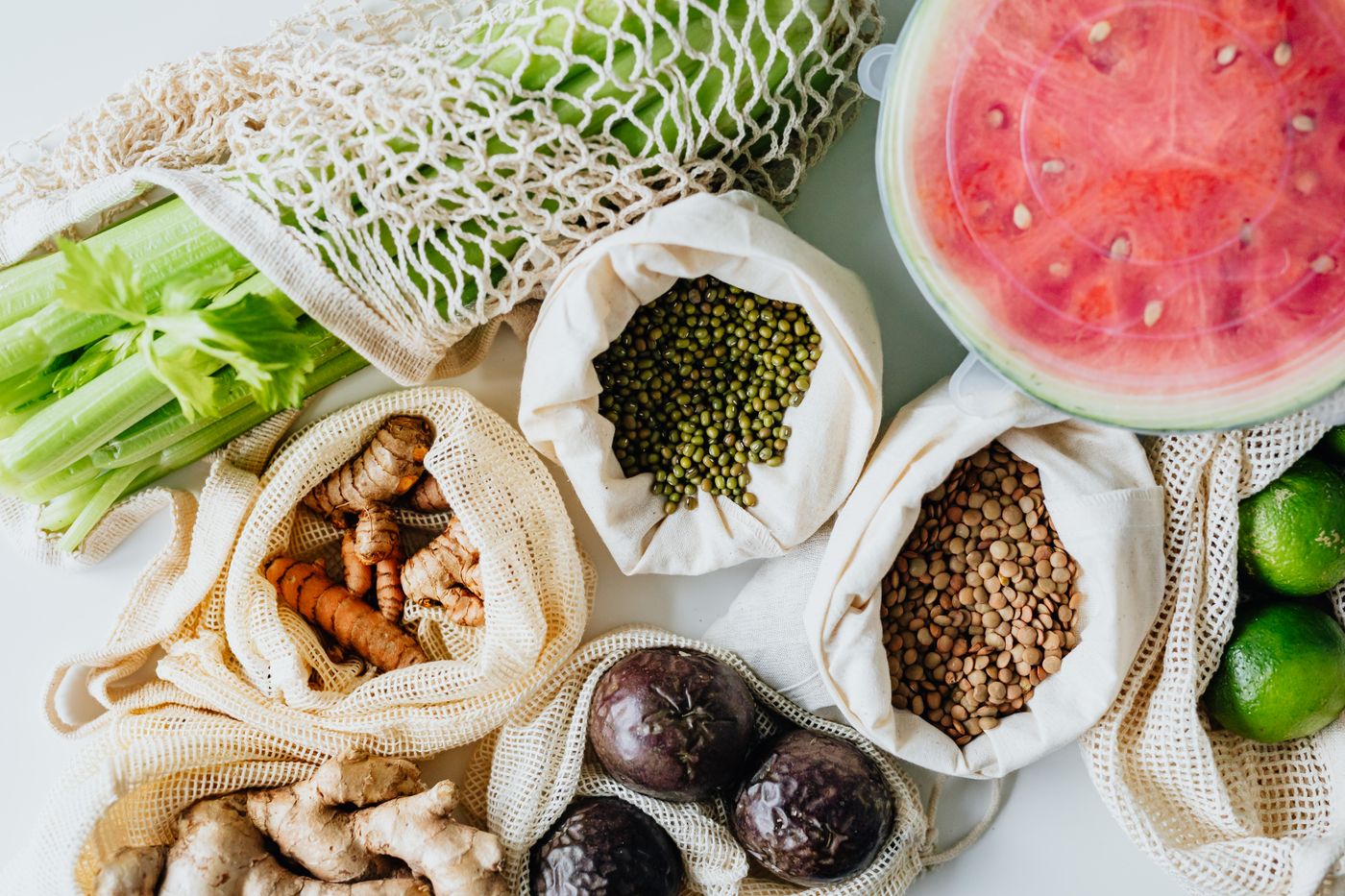 Fresh seasonal produce in reusable market bags
