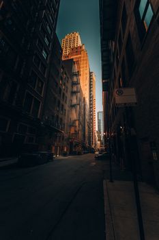 Capture of a sunlit alleyway in downtown Chicago, highlighting urban architecture.