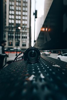 Close-up of DSLR camera on a city street in Chicago, capturing urban vibes.