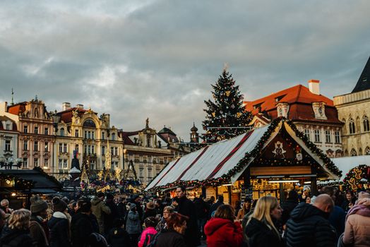 Vibrant Christmas market in Prague's Old Town Square showcasing festive stalls and decorations.