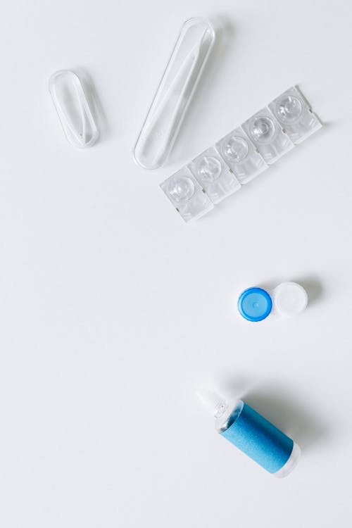 Flatlay of Contact Lens Items on White Surface