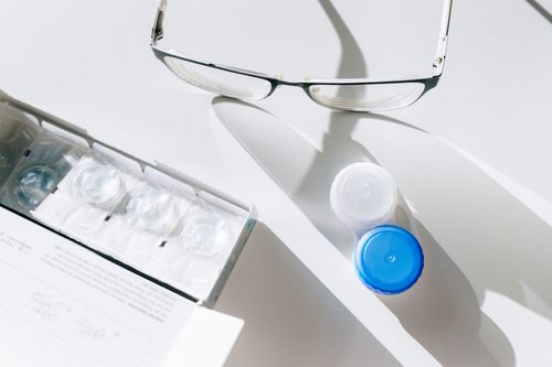 Free Flat lay of eyeglasses, contact lenses, and case highlighting everyday vision care essentials. Stock Photo