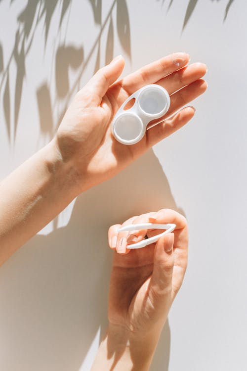 Free Person Holding Contact Lenses Container Stock Photo