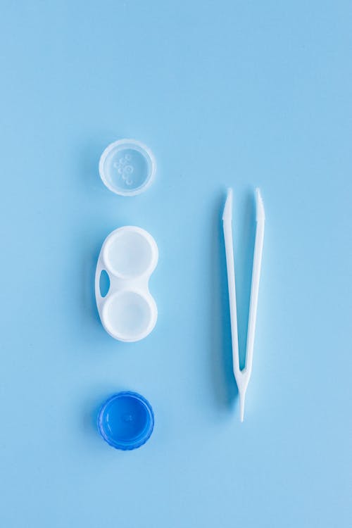 White and Blue Contact Lens Container on the Blue Table