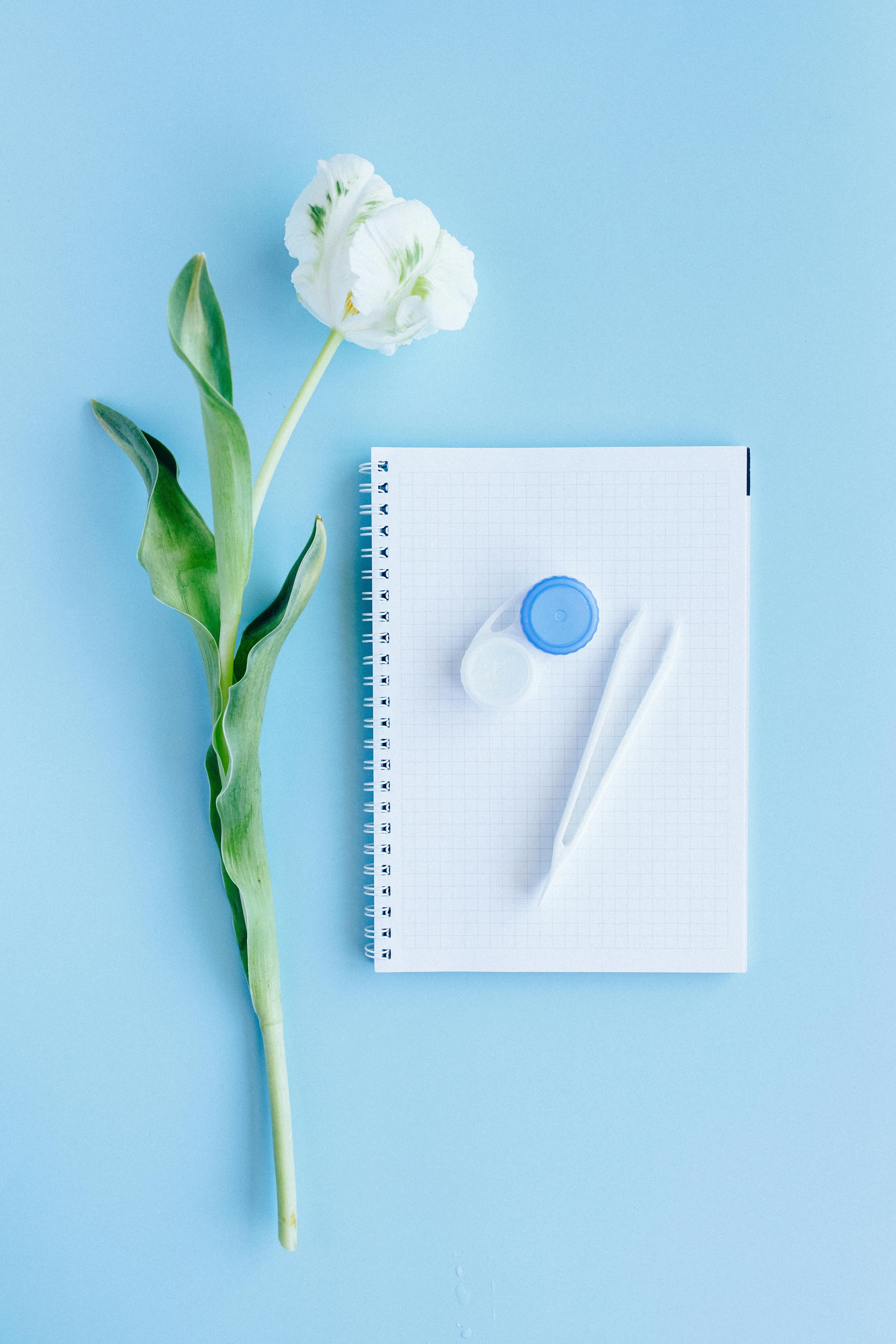 contact lens container on top of a notebook