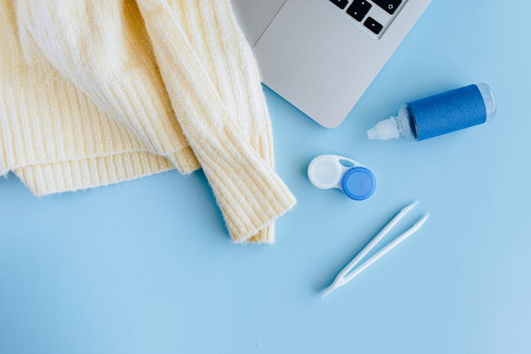 Close-Up Shot Of Plastic Bottle Beside A Tweezers