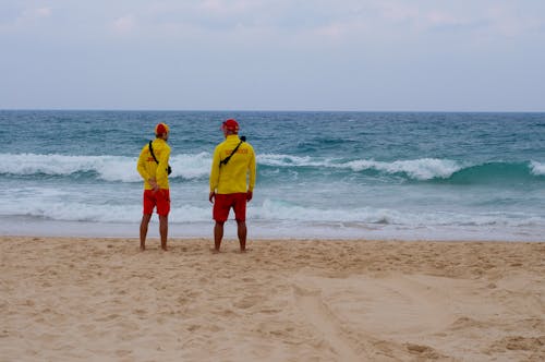 Two People Standing on the Beach