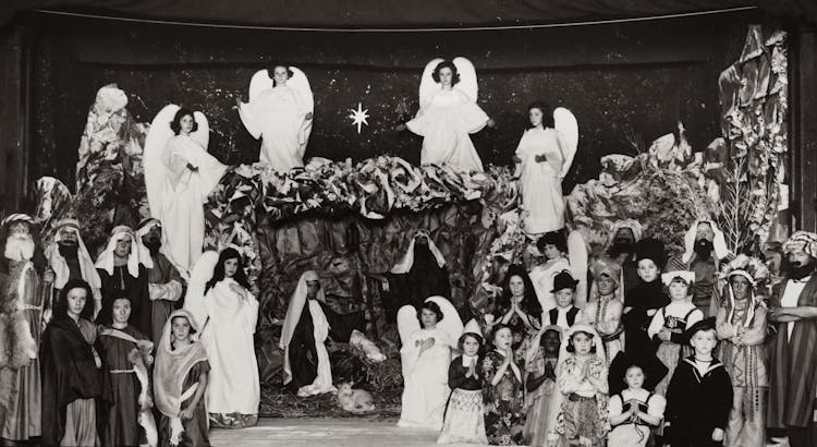 Grayscale Photo Of Children Wearing Costumes At A Christmas Presentation