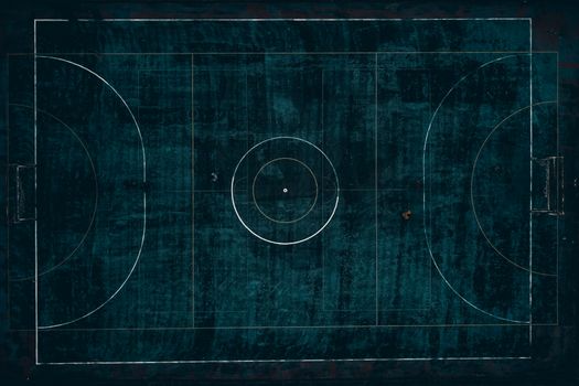 Drone top view of outdoors football field with dark blue surface located in suburb in daylight