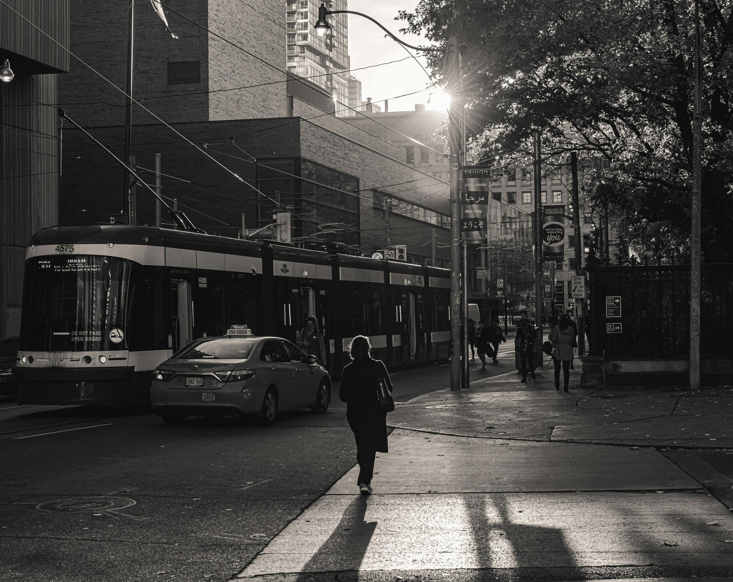Free Black and white street photo capturing a tram in downtown Toronto at daylight. Stock Photo