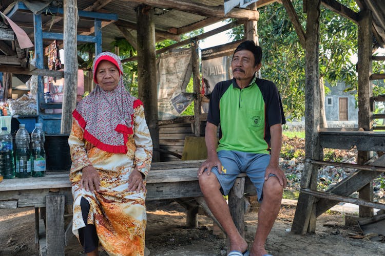 Ethnic Woman And Man Under Old Construction Roof