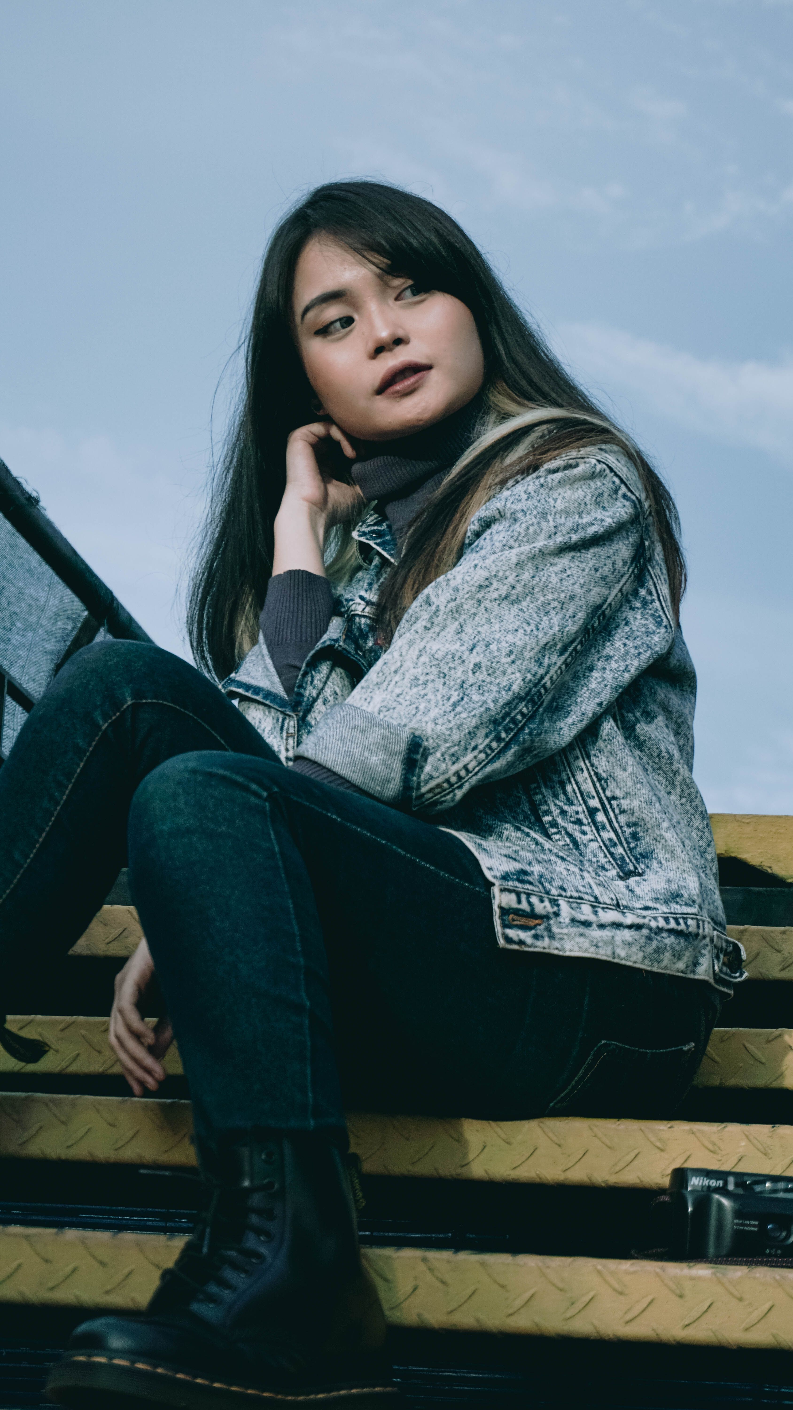 Portrait of Woman in Jean Jacket Sitting on Stai · Free Stock Photo