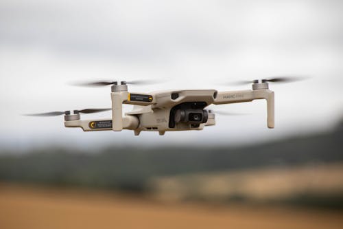 Free White and Black Drone in Mid Air Stock Photo