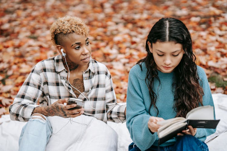 Diverse Friends Spending Time In Autumn Park In Daytime