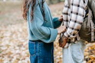 Crop couple standing in park