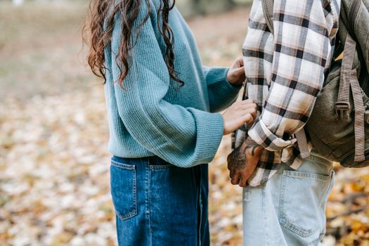 Crop couple standing in park