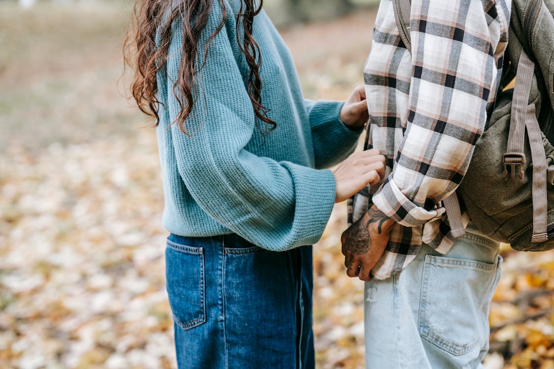 Free Crop couple standing in park Stock Photo