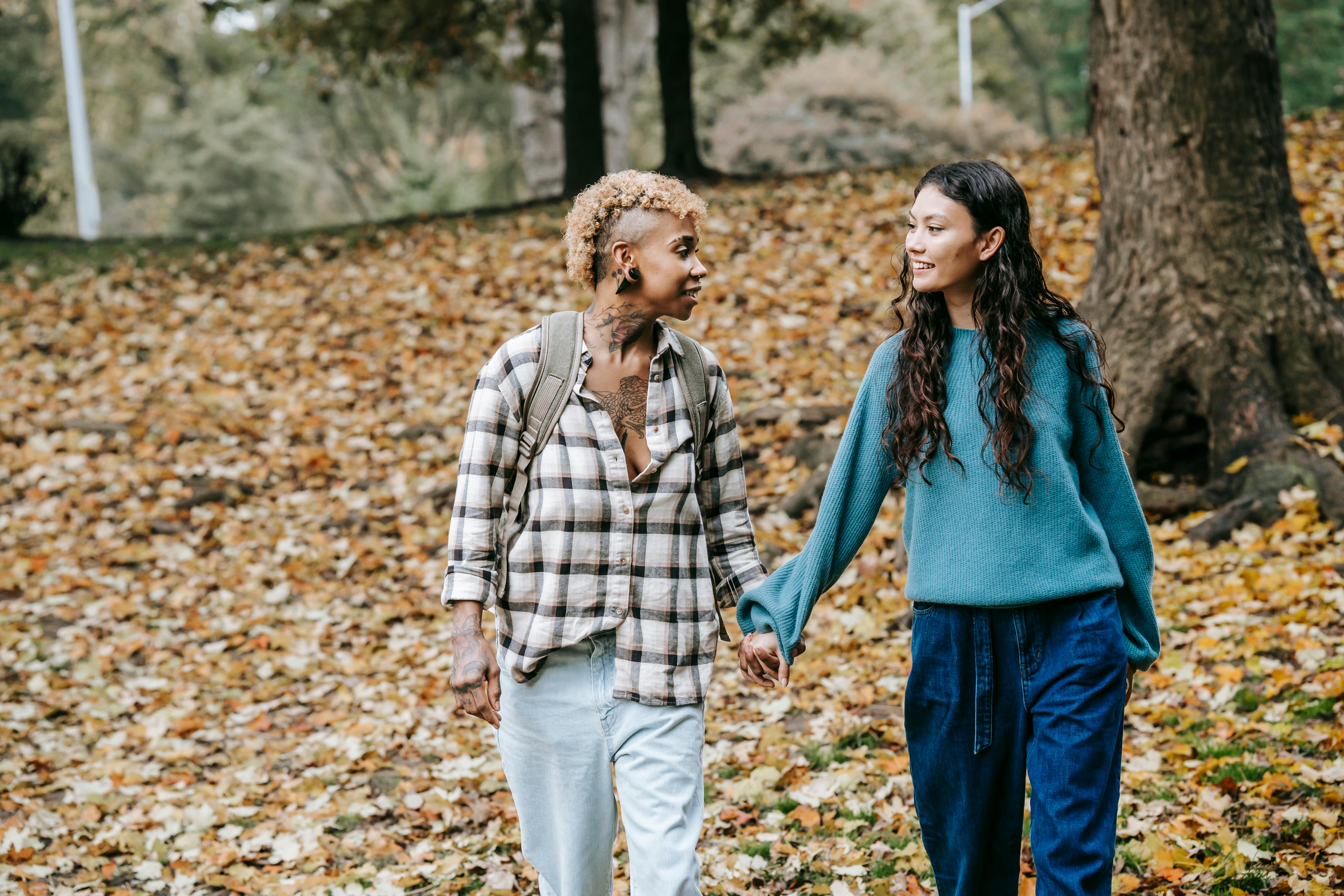 romantic multiethnic homosexual couple walking in park