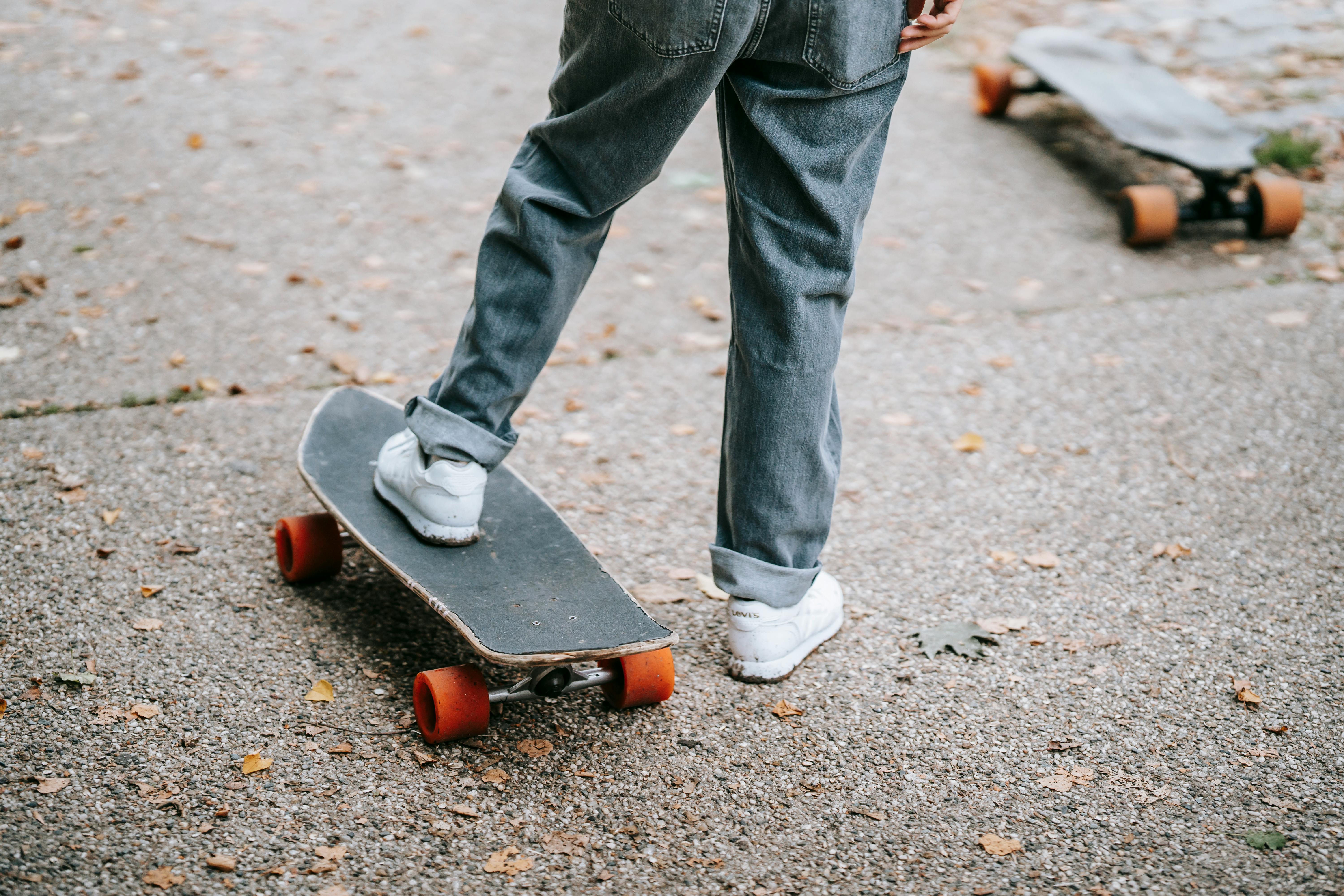 skater standing on skateboard on street in daytime