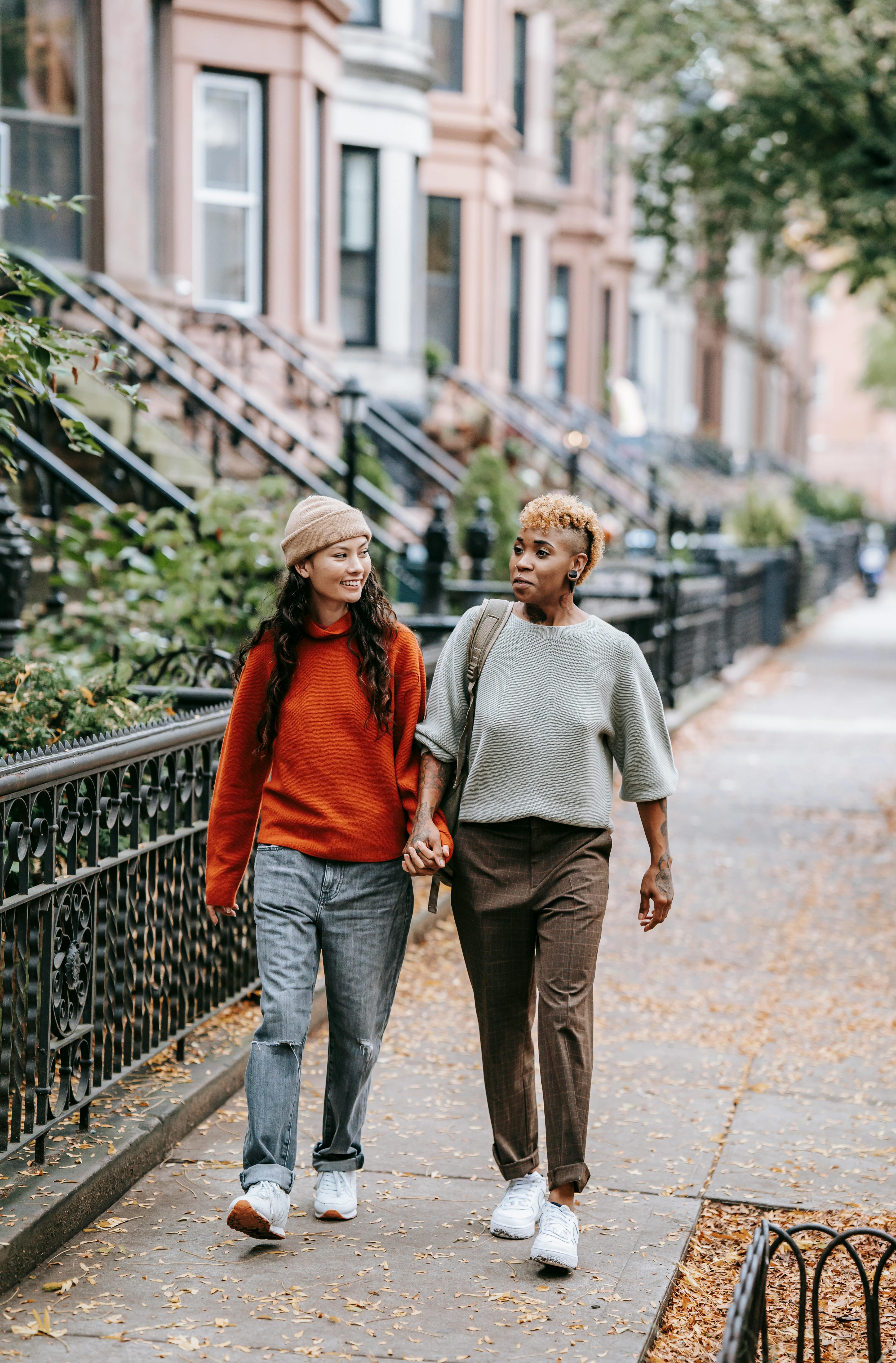 diverse lesbian couple walking on street