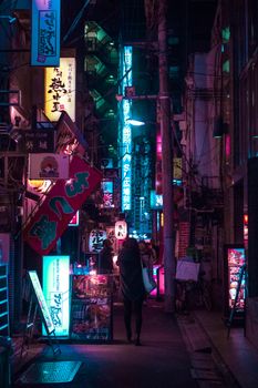 Explore the vibrant neon-lit streets of Tokyo at night, capturing the city's lively atmosphere.. explore, vibrant, neon