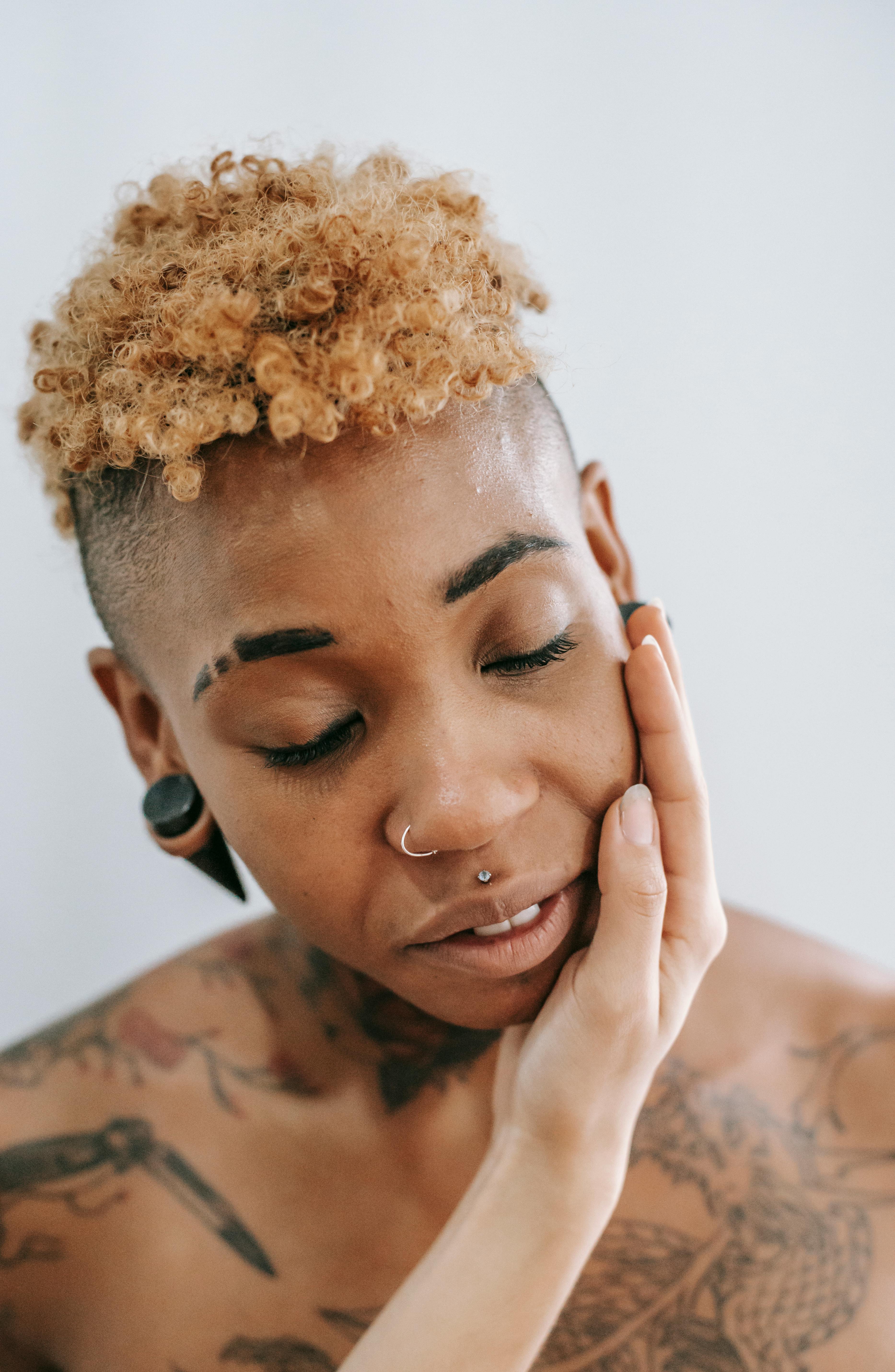 unrecognizable woman touching cheek of black woman