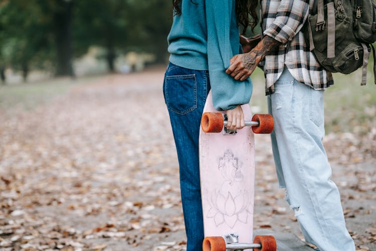 Crop Couple With Longboard In Park