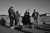 Grayscale Photo of People Playing Instruments