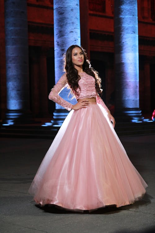 Free An Elegant Woman in Pink Dress Posing Stock Photo