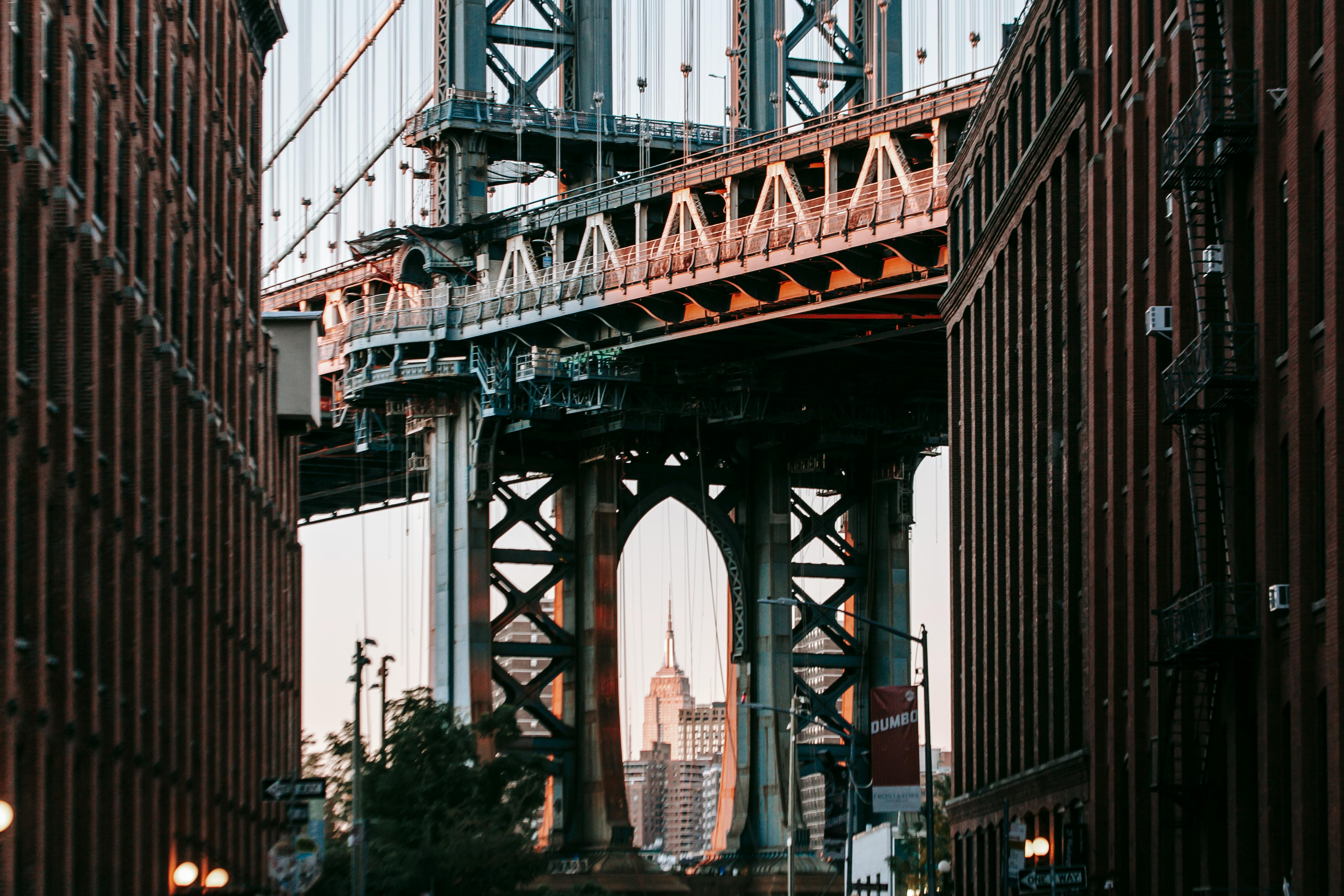 bridge with metal arch among concrete buildings