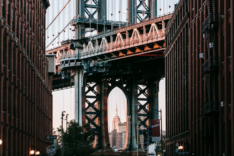 Bridge With Metal Arch Among Concrete Buildings