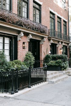 Beautiful brick townhouse with lush greenery and classic details.