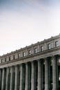 Low angle of exterior of historic James A. Farley Post Office with pillars and windows in center of New York City in soft daylight