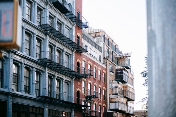 Cast-iron loft facades with fire escapes — photo by Charles Parker on Pexels
