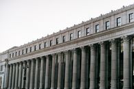 From below of facade of famous James A Farley Post Office with columns and windows in center of New York at daytime