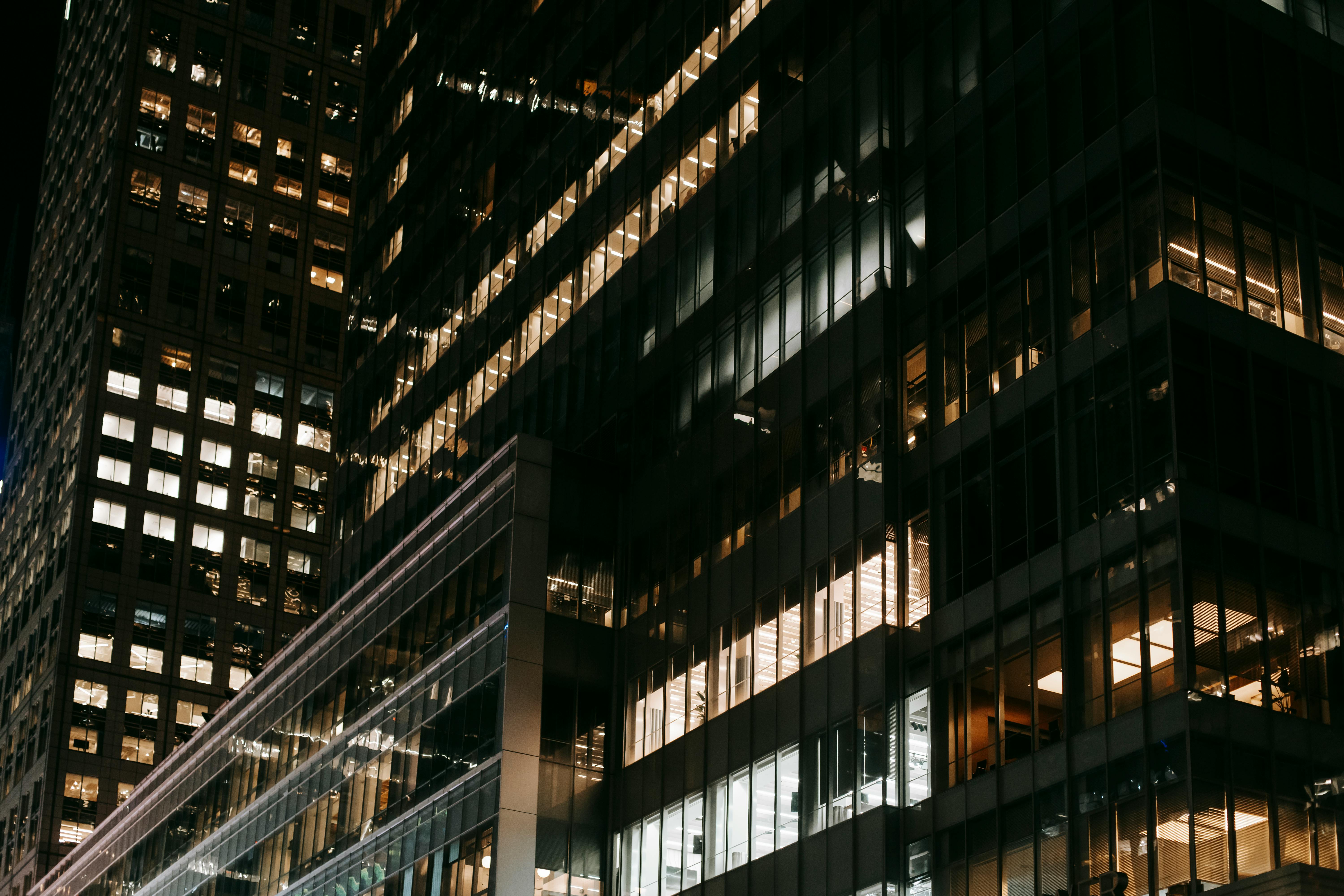 contemporary skyscrapers with bright electric lights at night