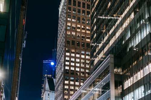 Modern skyscrapers with glass walls and bright lights