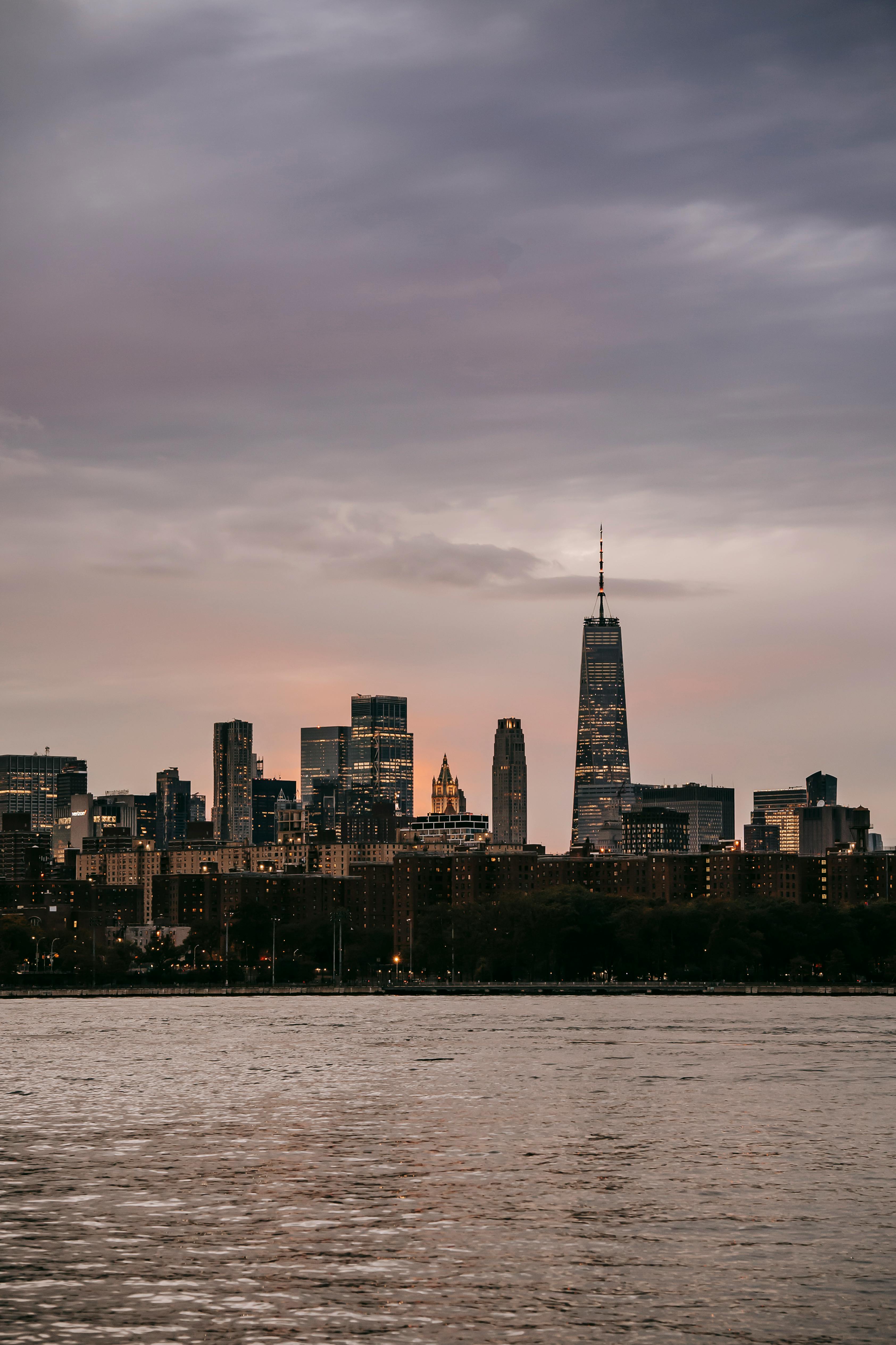 cityscape of modern megapolis with skyscrapers on river bank