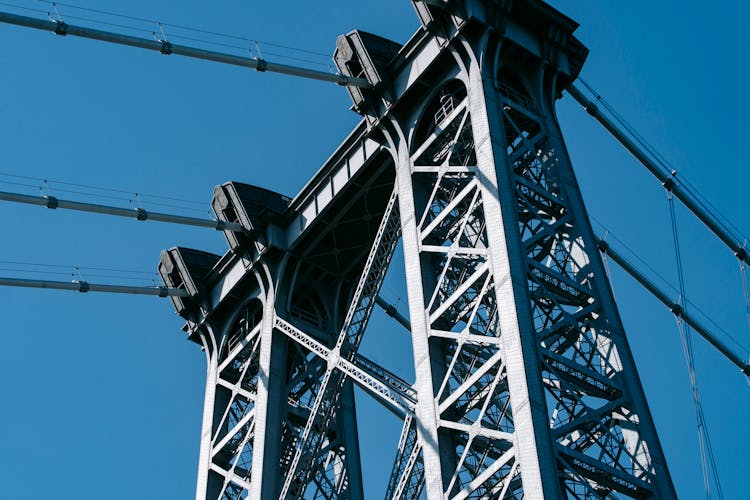 Cable Metal Construction Of Bridge Against Blue Sky