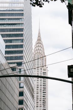 A vertical shot capturing the iconic Chrysler Building amidst New York City's skyscrapers.