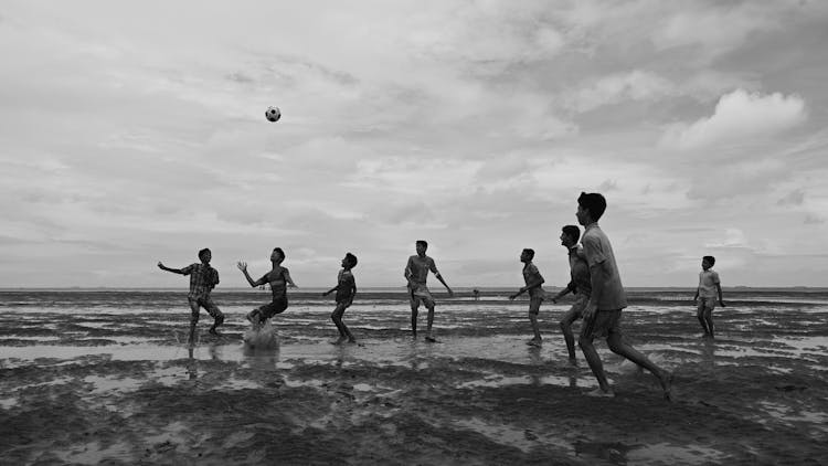 Boys Playing Soccer On Beach