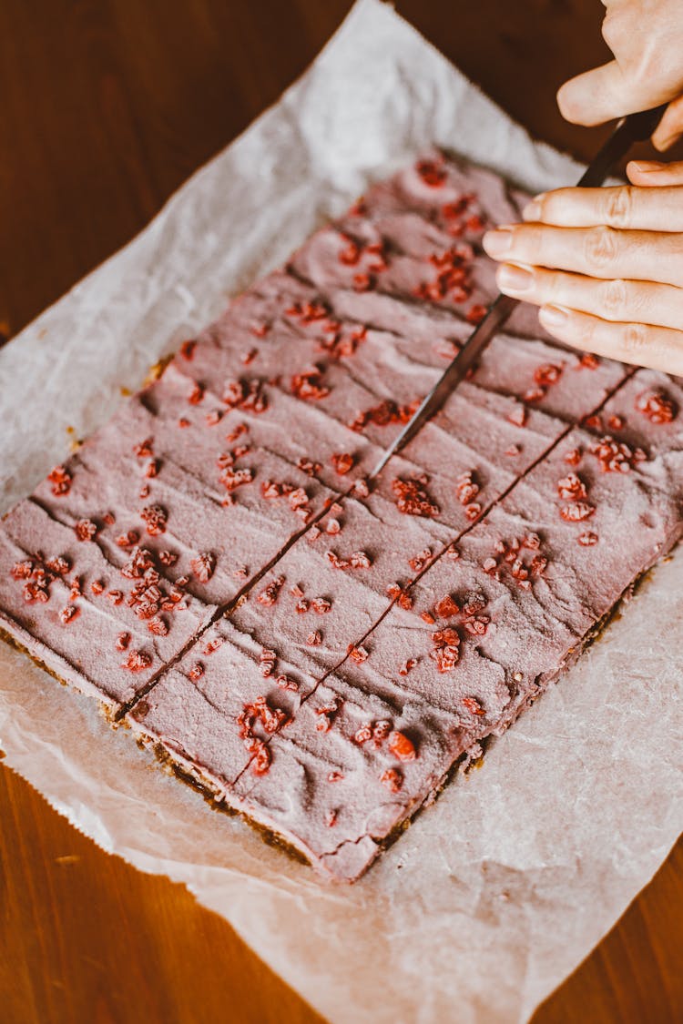 Hand Cutting Pink Cake With Knife