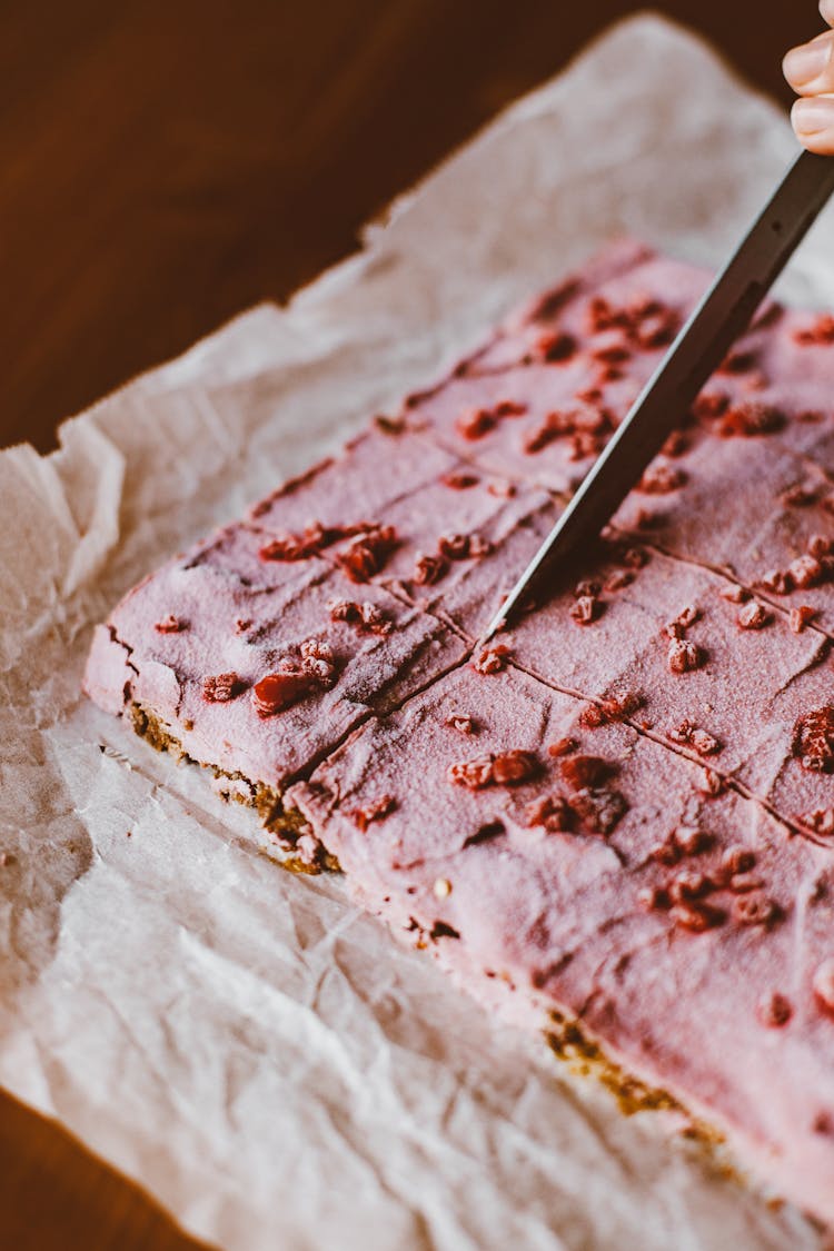 Hand Cutting Pink Cake With Knife