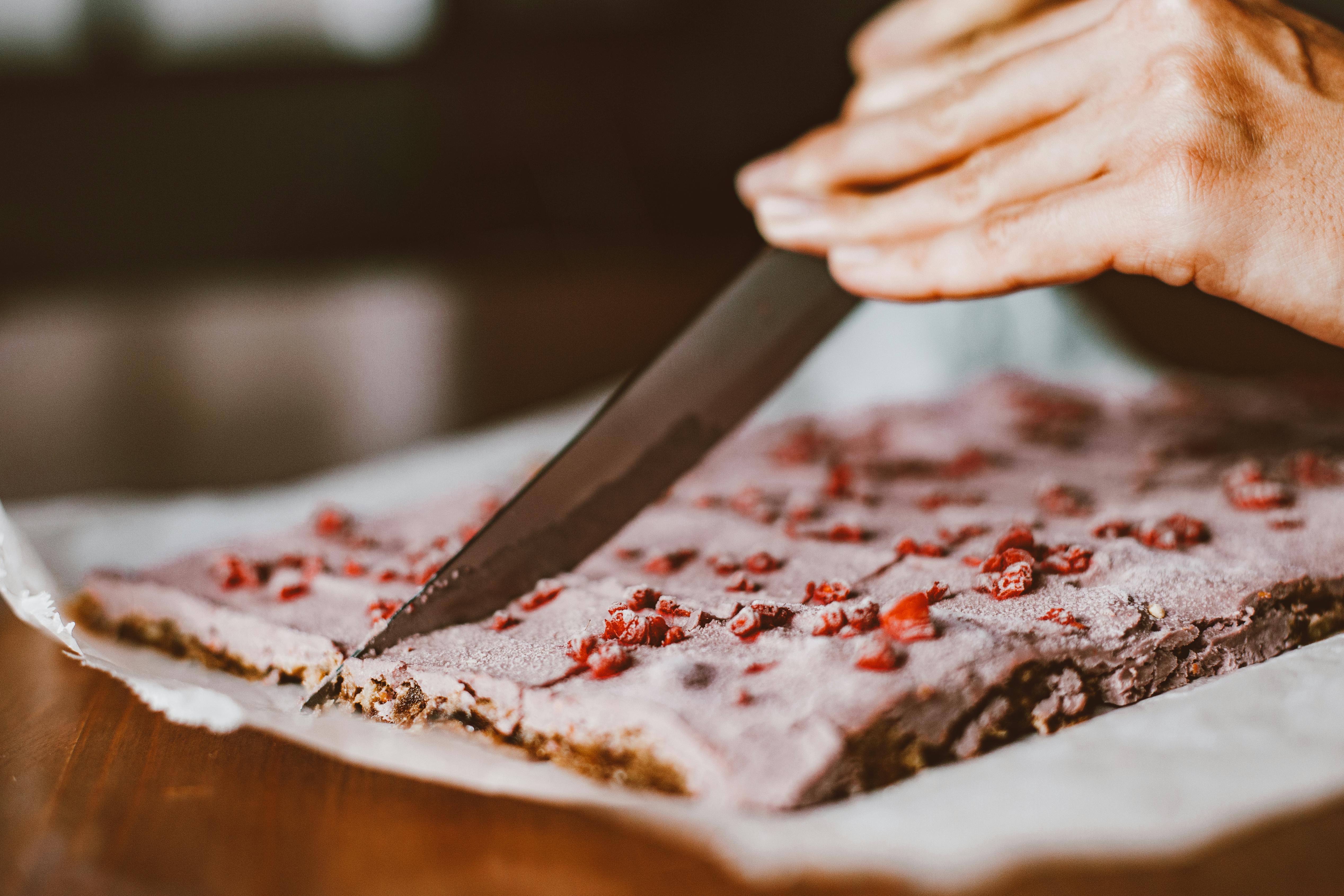 woman cutting cake with a sharp knife