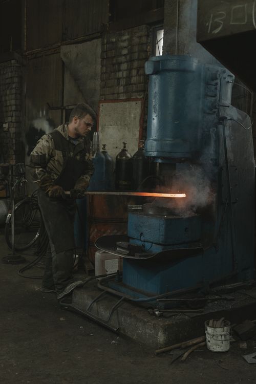 Boss Machine Forging Man Forging Metal using a Machine · Free Stock Photo