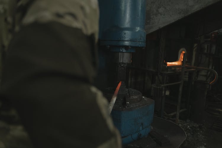 Person Forging A Hot Metal With A Machine